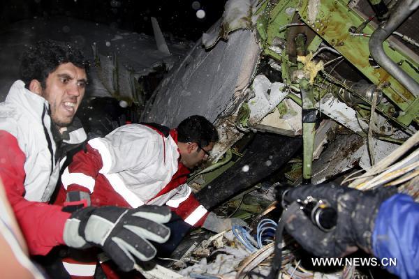 Rescuers work at the crash site of a passenger plane near the city of Uroumieh in northwest of Iran on Jan. 9, 2011.