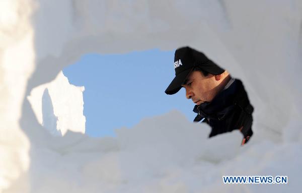 A contestant participates in a snow sculpture contest in Harbin, capital of northeast China's Heilongjiang Province, Jan. 10, 2011. 