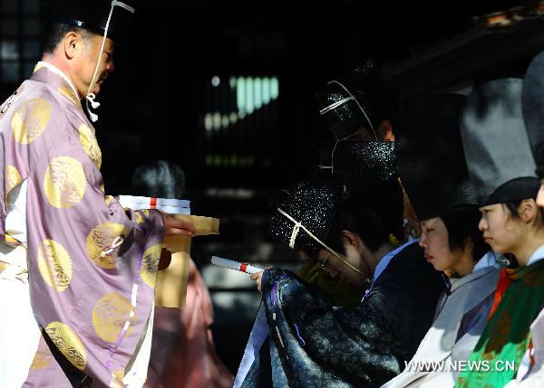 Youths receive books during the 'Genpuku' ceremony held in Meiji Shrine in Tokyo, capital of Japan, on Jan. 10, 2010, the Coming of Age Day.
