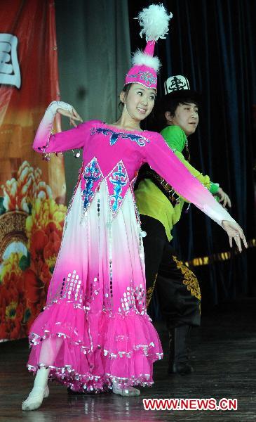 A Chinese actor and actress dance during a performance in Bishkek, Kyrgyzstan, Jan. 10, 2011.