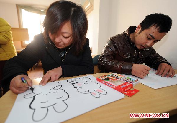 Handicapped residents draw pictures during their painting lesson in Hangzhou, capital of east China's Zhejiang Province, Jan. 10, 2010.