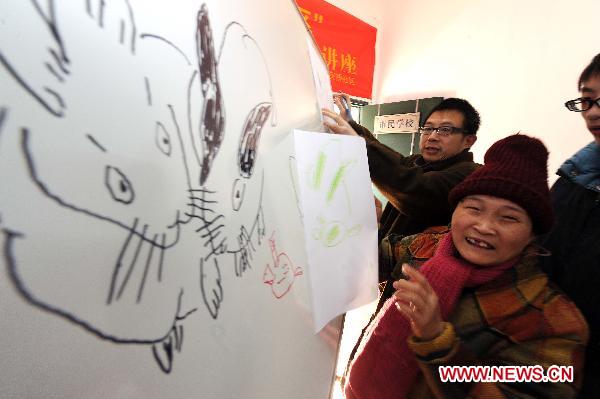 A handicapped resident draws a picture during a painting lesson in Hangzhou, capital of east China's Zhejiang Province, Jan. 10, 2010. 