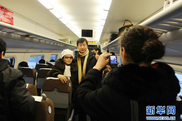 Passengers take photos to record the first journey on the new high-speed rail link between Jilin and Changchun, Jan.11, 2011. 