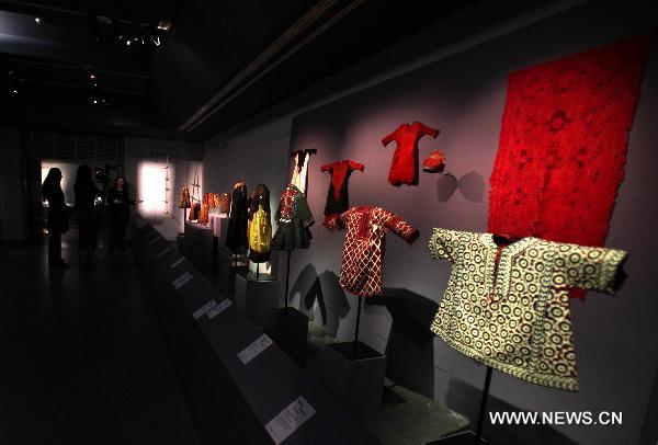 Audience visit an exhibition of Asian children's clothing at Guimet Museum in Paris, France, Jan. 10, 2011. 