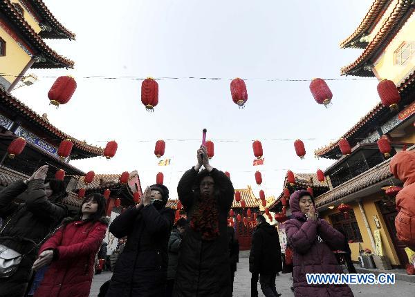 Buddhists pray at the Jianfu Guanyin Temple in north China's Tianjin, Jan. 11, 2011. 