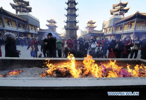 Buddhists pray at the Jianfu Guanyin Temple in north China's Tianjin, Jan. 11, 2011. 