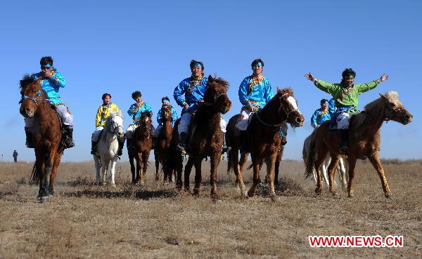 People take part in a horse racing competition in Etogqian Qi, north China's Inner Mongolian Autonomous Region, Jan. 12, 2011. 