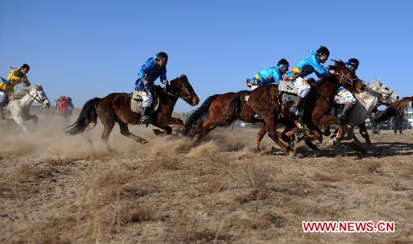People participate a horse racing competition in Etogqian Qi, north China's Inner Mongolian Autonomous Region, Jan. 12, 2011. 