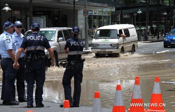 Policemen patrol in flooded streets of Brisbane, Queensland, Australia on Jan. 12, 2011. 