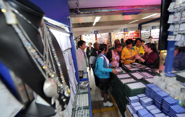 File photo taken on Oct. 14, 2010 shows people choosing small items in Yiwu, eastern China's Zhejiang Province. 