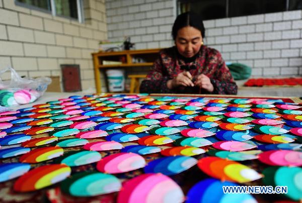 Regong artist Zhencuo makes barbola in the Longwu area of Huangnan Tibetan Autonomous Prefecture, northwest China's Qinghai Province, Jan. 12, 2011. 