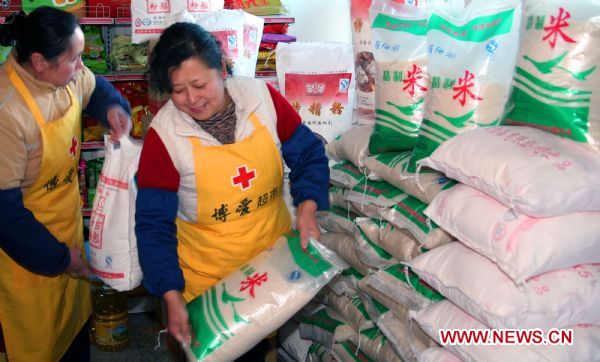 Employees prepare some daily necessities for poor families in a supermarket in Beijing, capital of China, ahead of Chinese Spring Festival, which falls on Feb. 3 this year.