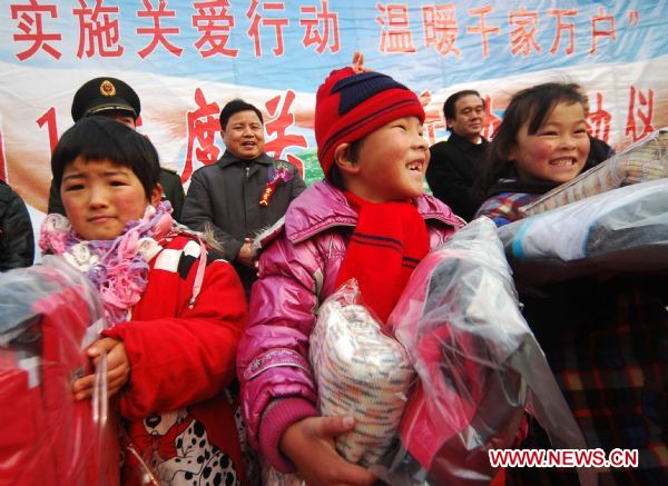 Representatives of orphaned and handicapped children are presented clothes in Chaohu City, east China's Anhui Province, Jan. 14, 2011, ahead of Chinese Spring Festival, which falls on Feb. 3 this year.