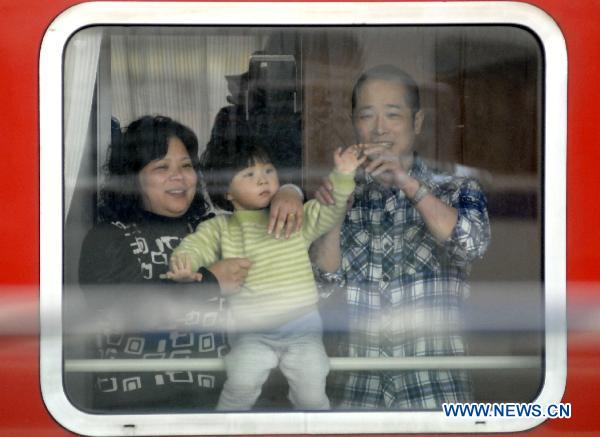 Photo taken on Jan. 15, 2011 shows a couple with their child on the train in Nanjing, capital of east China&apos;s Jiangsu Province. 