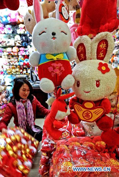 A vendor sets rabbit toys in her store in Yiwu Merchandise Market in east China's Zhejiang Province, Jan. 16, 2011.