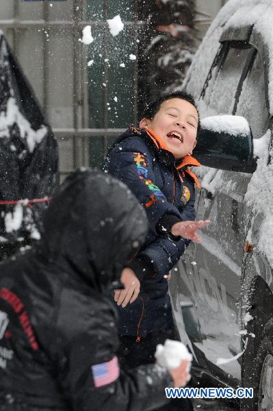 Children play with snow in Guiyang, capital of southwest China's Guizhou Province, Jan. 17, 2011. Rain, snow and ice hit the province again from Jan. 16. The lowest temperature of the province dropped to minus 6.1 degrees Celsius at Weining County, which is located in the Wumeng mountain areas. 
