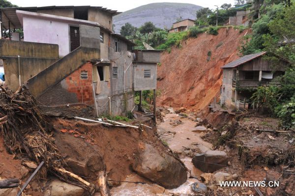 Flood runs in Caleme slum, outside Teresopolis, Brazil, Jan. 16, 2011. 