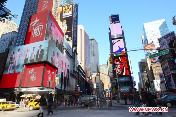 Footages of a short film promoting China (L) are shown on the screens at the Times Square in New York, US, Jan. 17, 2011. The video will be on until Feb. 14, 2011.