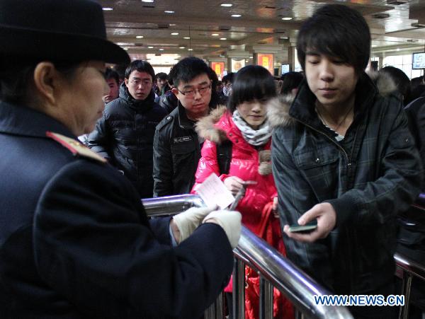 Passengers have the tickets checked at a railway station in Shijiazhuang, capital of north China's Hebei Province, Jan. 18, 2011.
