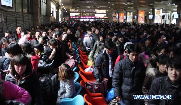 Passengers wait for trains at a railway station in Shijiazhuang, capital of north China's Hebei Province, Jan. 18, 2011. 