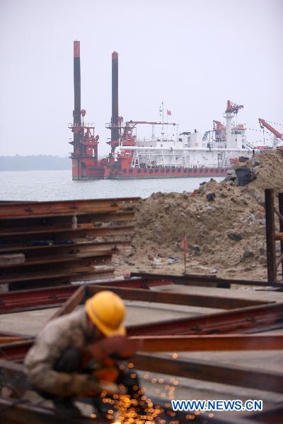Photo taken on Jan. 12, 2011 shows the construction site for expansion of Qinglan Port in Wenchang, south China's Hainan Province. The harbor will serve for transportation of huge equipments such as rocket components when the space launch center is ready. 
