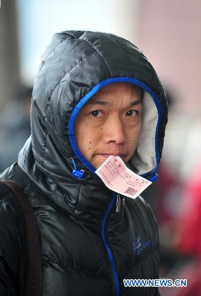 A passenger is seen in Wuchang Railway Station in Wuchang, central China&apos;s Hubei Province, Jan. 19, 2011, the first day of the 40-day Spring Festival travel rush.