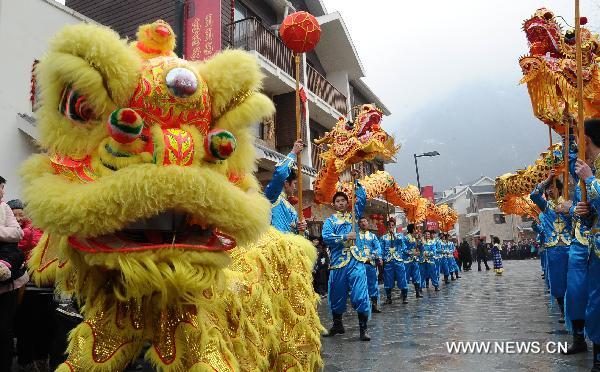 Local residents perform lion and dragon dances to celebrate the coming Spring Festival in Yingxiu Town of Wenchuan County, southwest China's Sichuan Province, Jan. 31, 2011. 