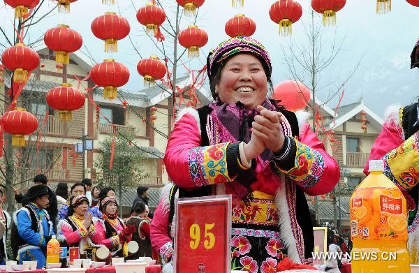 A woman smiles on a grand public banquet to celebrate the coming Spring Festival in Yingxiu Town of Wenchuan County, southwest China's Sichuan Province, Jan. 31, 2011. 