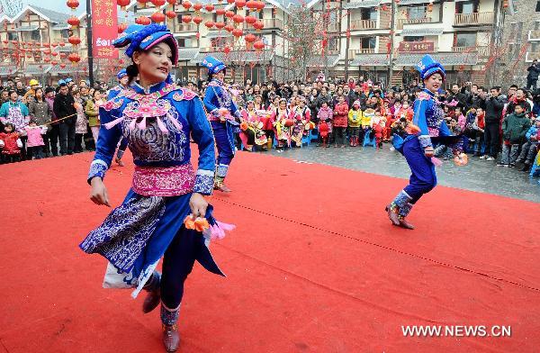 Local residents perform to celebrate the coming new year in Yingxiu Town of Wenchuan County, southwest China's Sichuan Province, Jan. 31, 2011.