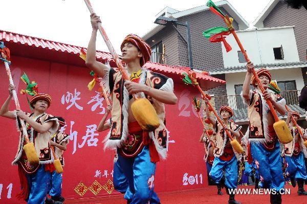 Local residents perform to celebrate the coming new year in Yingxiu Town of Wenchuan County, southwest China's Sichuan Province, Jan. 31, 2011.