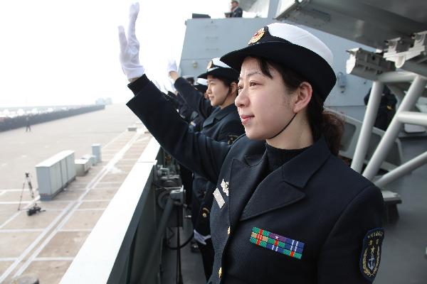 Soldiers wave hands on board and prepare to set sail at a port in Zhoushan, east China's Zhejiang Province, Feb. 21, 2011. 