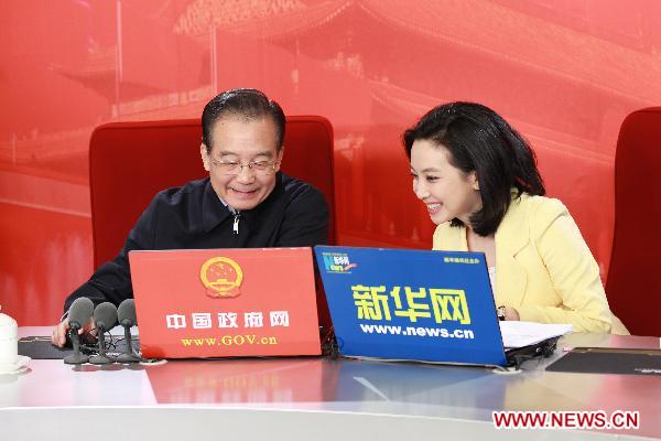 Chinese Premier Wen Jiabao (L) prepares to hold an online chat with Internet users at two state news portals in Beijing, capital of China, Feb. 27, 2011. 