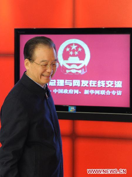 Chinese Premier Wen Jiabao arrives at the venue for an online chat with Internet users at two state news portals in Beijing, capital of China, Feb. 27, 2011.