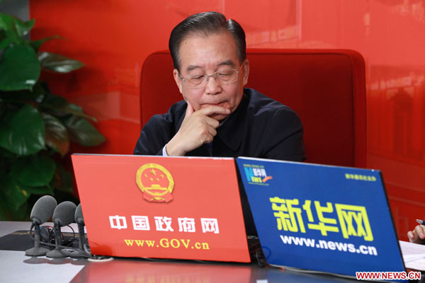 Chinese Premier Wen Jiabao reacts during an online chat with Internet users at two state news portals in Beijing, capital of China, Feb. 27, 2011. 
