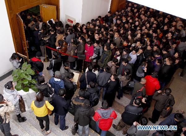 Journalists wait for information materials at an auditorium of Chinese People's Political Consultative Conference (CPPCC) in Beijing, capital of China, March 1, 2011. 