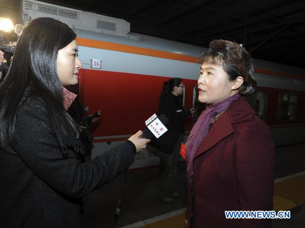 Mai Shirui, a deputy to the Fourth Session of the 11th National People's Congress (NPC) from central China's Henan Province, responses to a journalist as she arrives in Beijing, capital of China, March 2, 2011. 