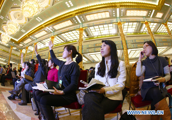 Journalists raise hands during a news conference on the Fourth Session of the 11th National Committee of the Chinese People&apos;s Political Consultative Conference (CPPCC) at the Great Hall of the People in Beijing, capital of China, March 2, 2011.