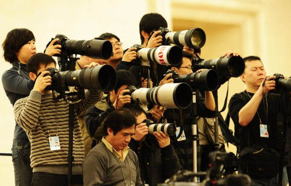 Journalists work during the news conference on the Fourth Session of the 11th National People's Congress (NPC) at the Great Hall of the People in Beijing, capital of China, March 4, 2011. 