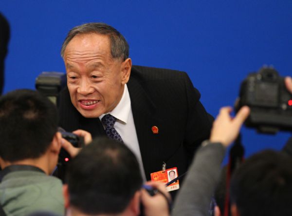 Li Zhaoxing (Top), spokesman for the Fourth Session of the 11th National People's Congress (NPC), talks with journalists after the news conference on the Fourth Session of the 11th NPC at the Great Hall of the People in Beijing, capital of China, March 4, 2011. 