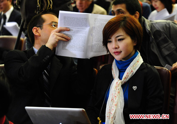 Journalists work during the opening meeting of the Fourth Session of the 11th National People&apos;s Congress (NPC) at the Great Hall of the People in Beijing, capital of China, March 5, 2011. 