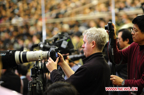 Journalists work during the opening meeting of the Fourth Session of the 11th National People&apos;s Congress (NPC) at the Great Hall of the People in Beijing, capital of China, March 5, 2011.