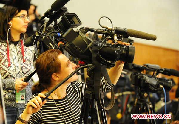 Journalists work during the opening meeting of the Fourth Session of the 11th National People&apos;s Congress (NPC) at the Great Hall of the People in Beijing, capital of China, March 5, 2011. 