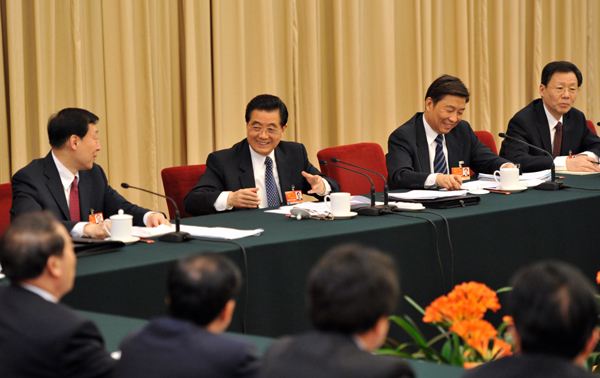 Chinese President Hu Jintao (R 3rd) joins in a panel discussion with national legislators from eastern Jiangsu Province on March 5, 2011.