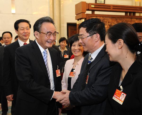 Chinese top legislator Wu Bangguo joins in a panel discussion with national legislators from Anhui Province on March 5, 2011. 