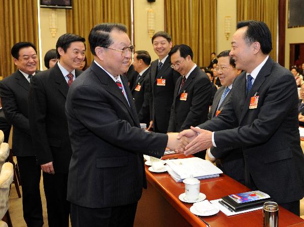 Li Changchun, a member of the Standing Committee of the Political Bureau of the Communist Party of China Central Committee, joins in a panel discussion with national legislators from the southwestern Sichuan Province on March 5, 2011.