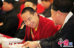 The 11th Panchen Lama, Bainqen Erdini Qoigyijabu, deliberates the government work report presented by Chinese Premier Wen Jiabao to the National People's Congress (NPC) with other political advisors at the annual session of the Chinese People's Political Consultative Conference (CPPCC).