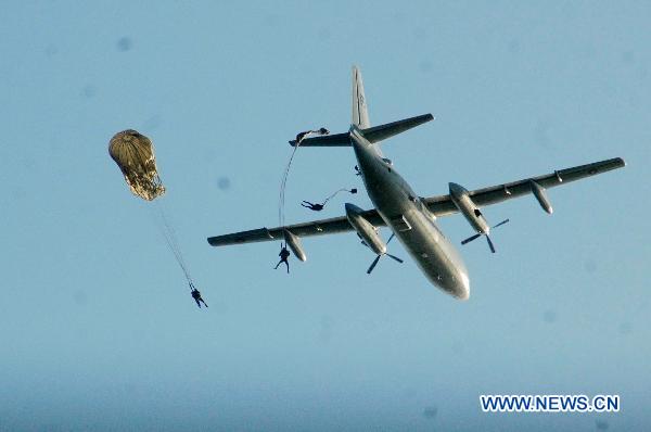 Commandos of Pakistan Navy jump from a plane during 'Peace-11 Exercises' multinational naval exercises in southern Pakistani port city of Karachi on March 9, 2011.