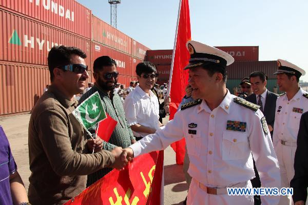 Huang Xiaohu (R front), commander of 8th escort flotilla sent by the Chinese Navy, shakes hands with a Pakistani man during the farewell ceremony, in Karachi, Pakistan, March 13, 2011. 