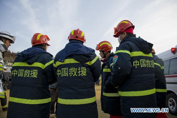 Members of the Chinese International Search and Rescue Team (CISAR) talk upon their arrival at the earthquake hit Ofunato city in Iwate prefecture, Japan, March 14, 2011.