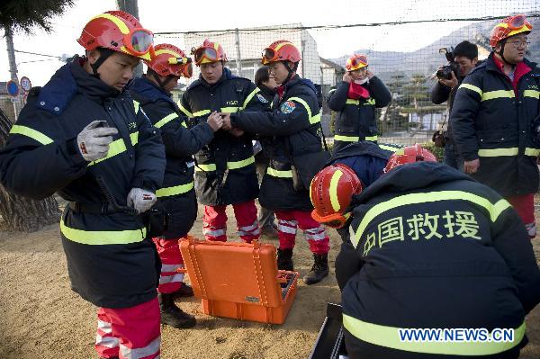 Members of the Chinese International Search and Rescue Team (CISAR) prepare to work after arriving at the earthquake hit Ofunato city in Iwate prefecture, Japan, March 14, 2011. 